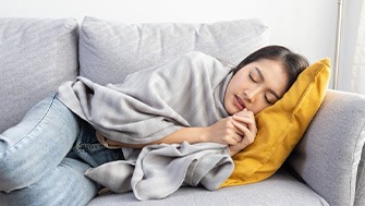 Lady rests on couch