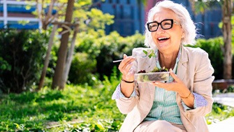 Lady enjoys salad outdoors